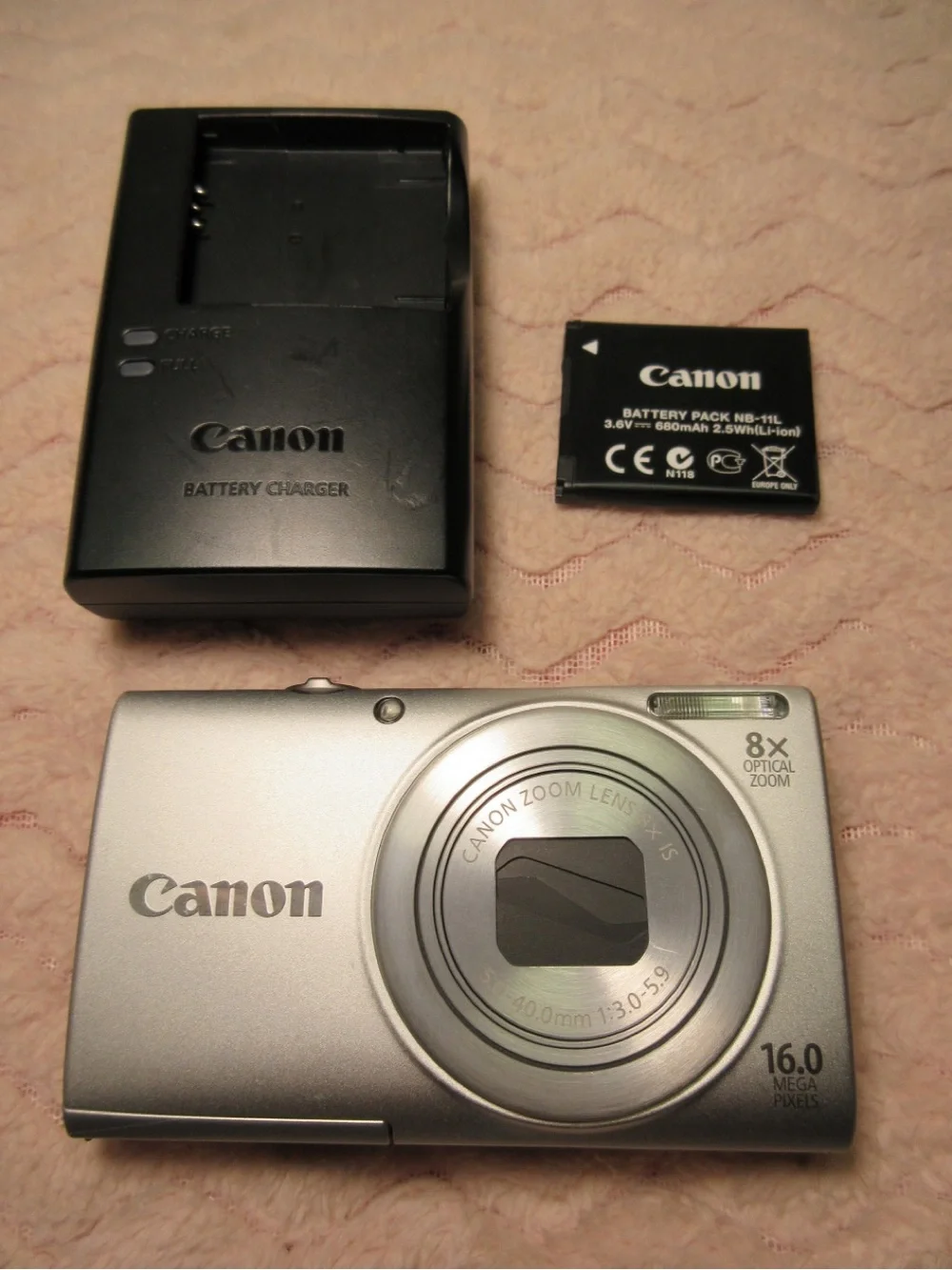 Canon Silver Compact Camera with Black Charger and Accessories